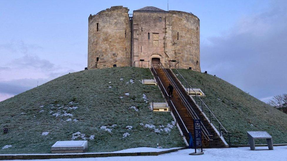 Snow gathered around Clifford's Tower in York