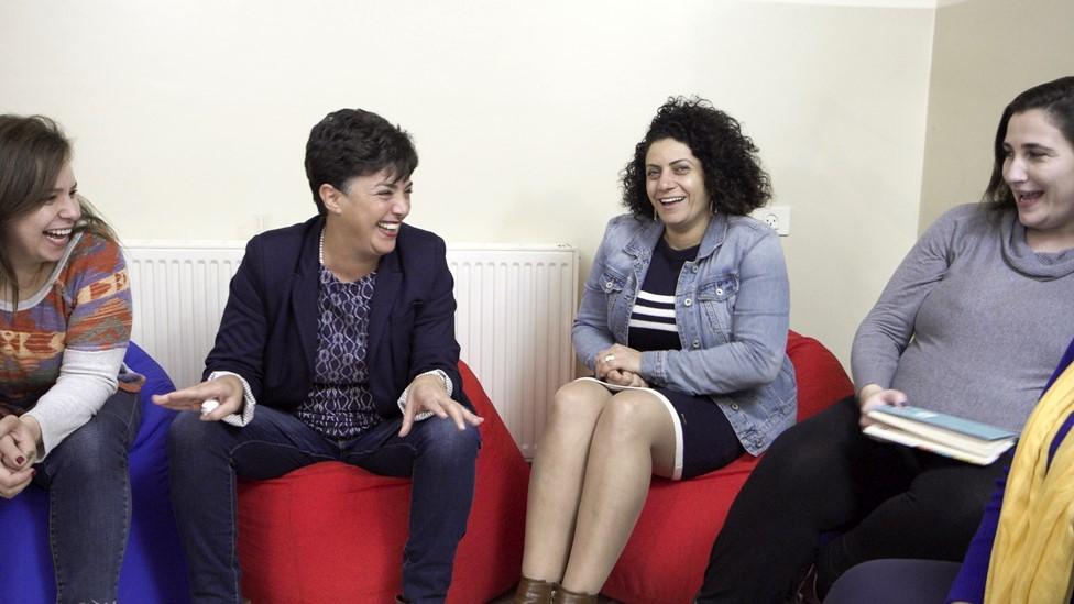 Women laugh during a meeting at Muntada Al-Jensaneya in Ramallah, in the occupied West Bank