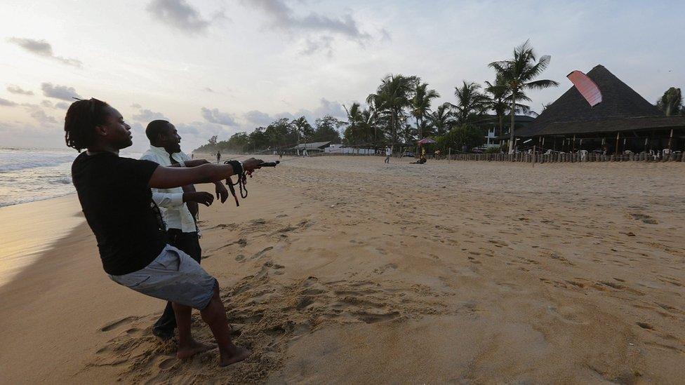 A man flying a kite on beach in Grand Bassam, Ivory Coast - Wednesday 23 November 2016