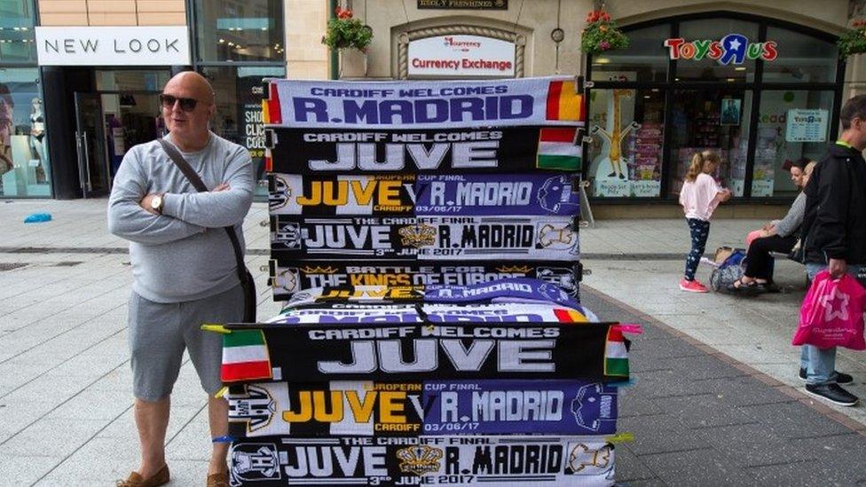 Man selling scarves in Queen Street