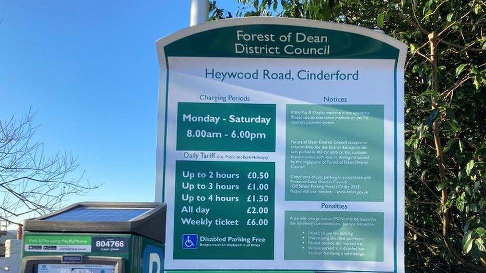 Forest of Dean District Council sign at Haywood Car Park detailing previous parking charges