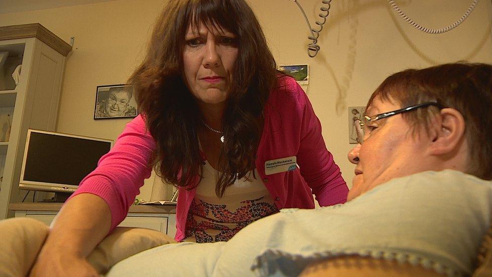 Pamela Mackenzie attends to a patient at the Dee View Court centre in Aberdeen