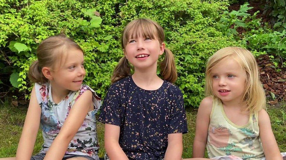 three girls sitting down.