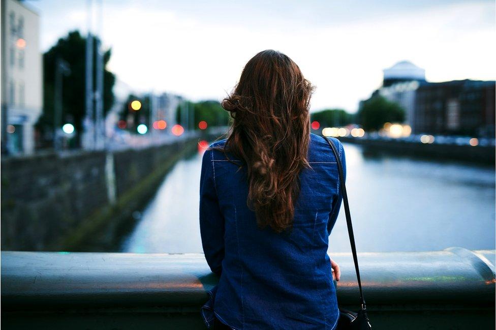 Woman looking from bridge