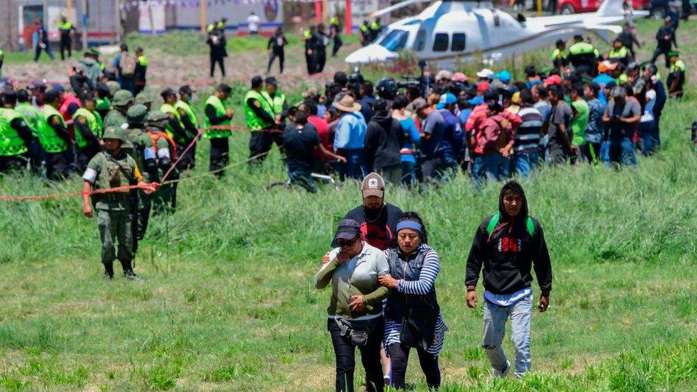 People leave the scene of the explosion in Tultepec Mexico July 2018