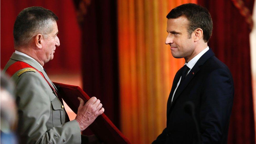 Emmanuel Macron (R) is presented the great chain of office of France's National Order of the Legion of Honour at the Elysee presidential Palace on 14 May 2017 in Paris.