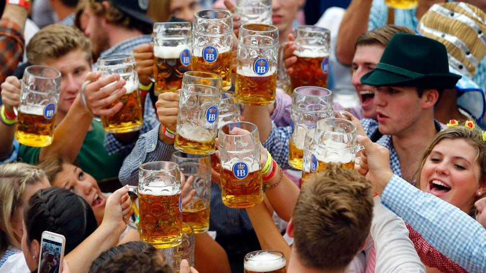 In this Sept. 19, 2015 file photo, people celebrate the opening of the 182nd Oktoberfest beer festival in Munich, southern Germany.