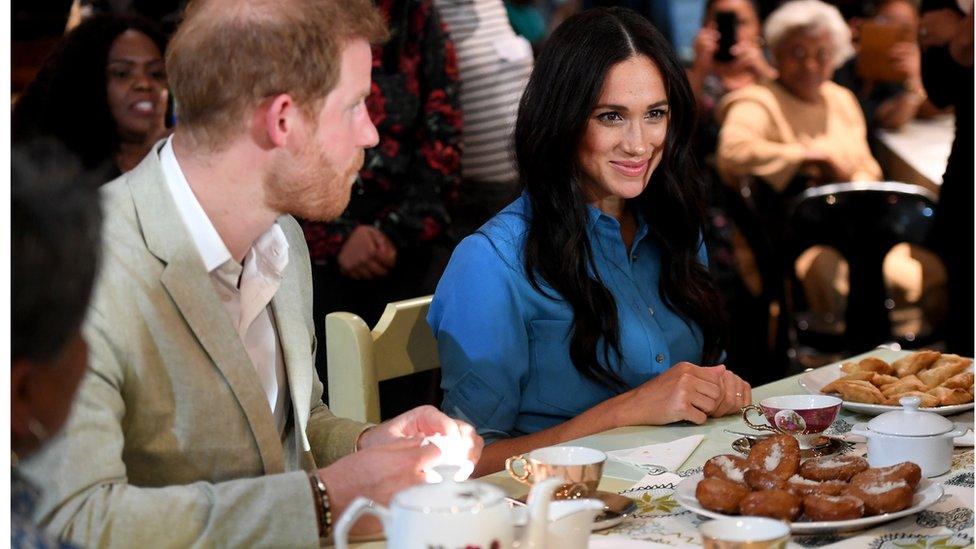 Prince Harry and Meghan are given tea and snacks at the museum