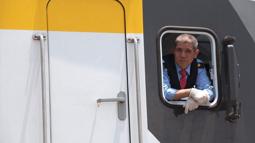 Chinese train engineer looks out the window of a train during a stop in Addis Ababa along the way of the Addis Ababa / Djibouti train line on 24 September 2016.