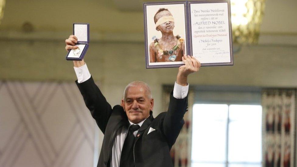 Secretary General of the Tunisian General Labour Union (UGTT) Houcine Abassi poses with the diploma and medallion during the Nobel Peace Prize award ceremony