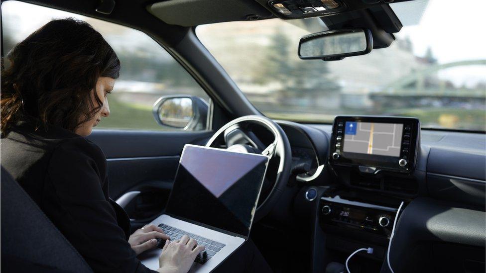 Woman in driverless car