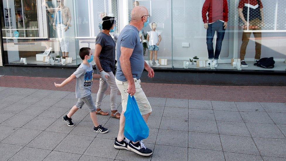 A family wearing facemasks in public