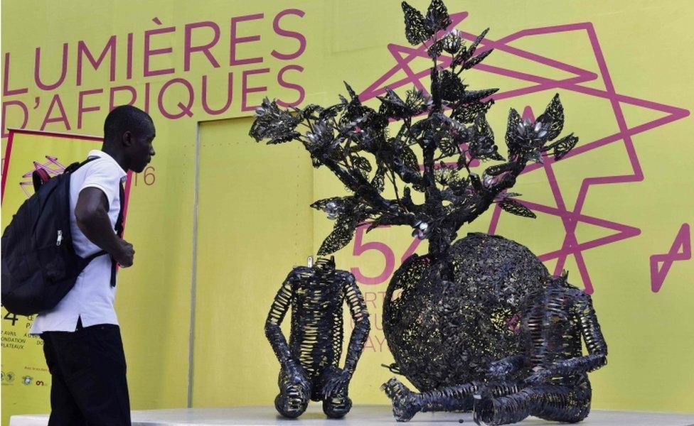 visitor looks at an artwork during the opening of the exhibition Lumieres dAfriques (Lights of Africa) at the Charles Donwahi Foundation in Abidjan on April 26, 2016.