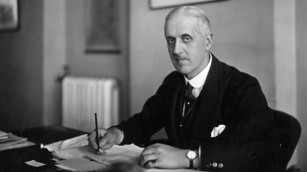 Sir Fabian Ware sitting at his desk