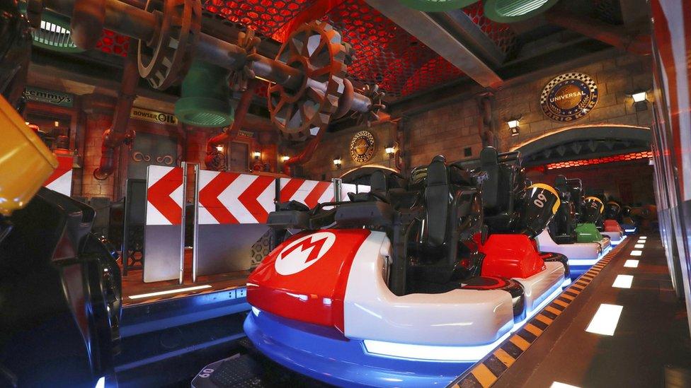 Mario Kart station - a rollercoaster-like boarding area with the carts modelled after Mario Kart go-karts