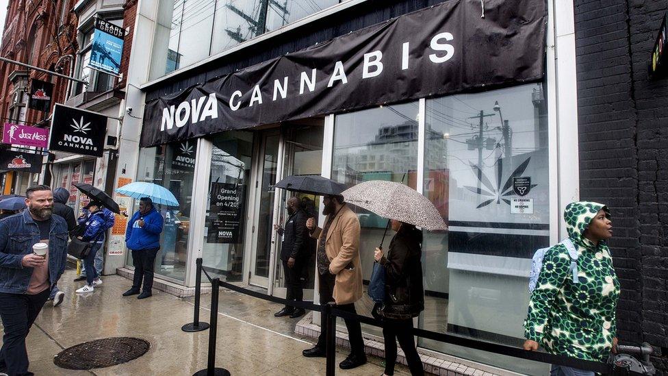 People line up for the opening of a legal cannabis store in Toronto