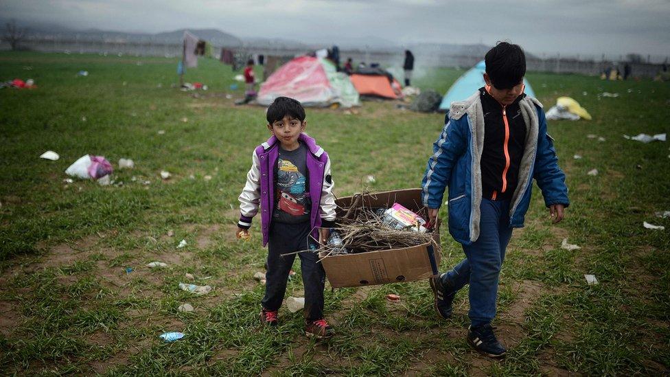 Children carrying fire wood at the Idomeni refugee camp.