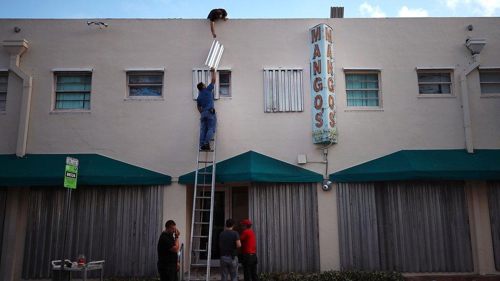 People boarding up building