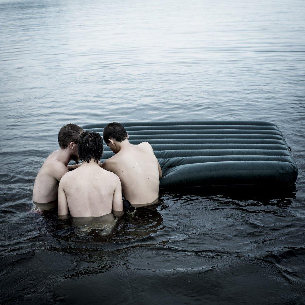 Three boys by an inflatable