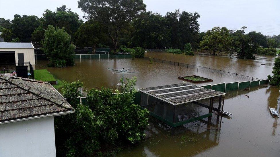 Floodwater completely submerges the backyards of properties on Ladbury Ave, in Penrith, New South Wales, Australia, 21 March 2021.