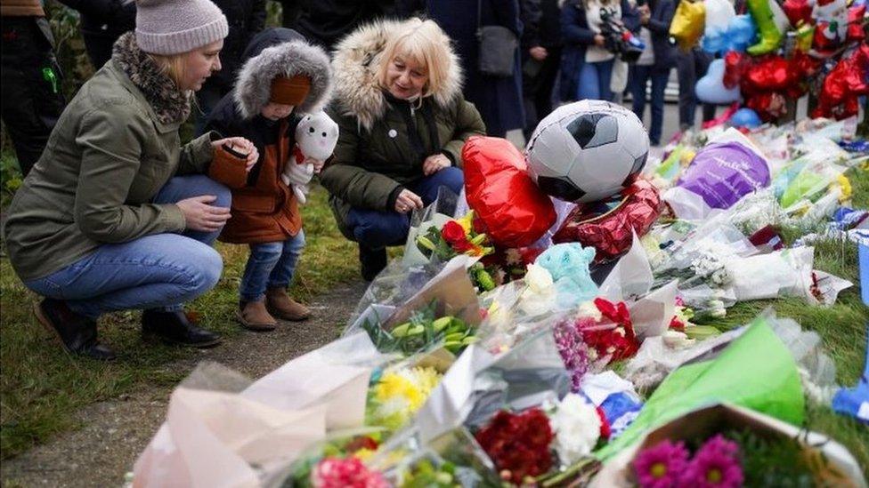 People lay flowers near to the house where Arthur lived