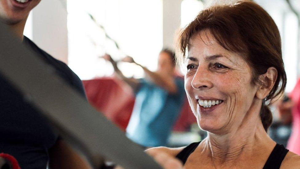 Woman uses equipment in gym