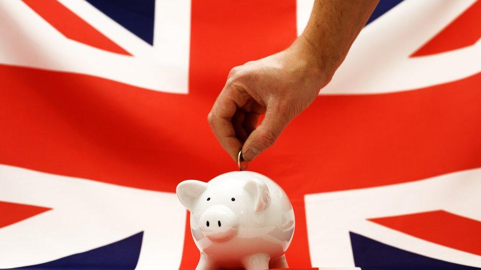 UK flag with piggy bank in front