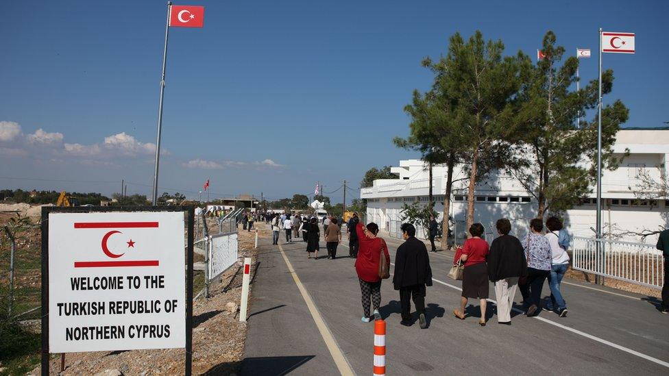 People cross the newly-opened Dherynia crossing, near the eastern village of Dherynia, on November 12, 2018.