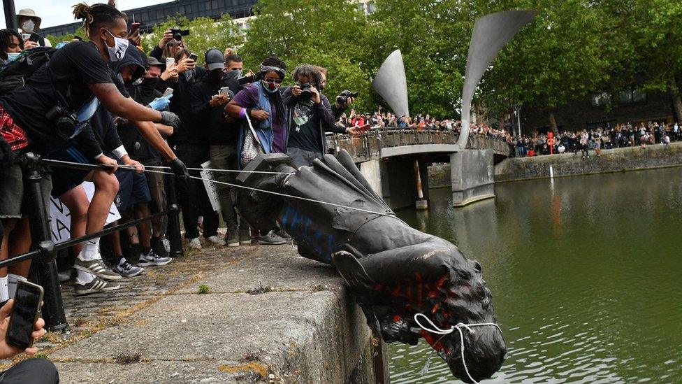 Protesters throw statue of Edward Colston into Bristol harbour