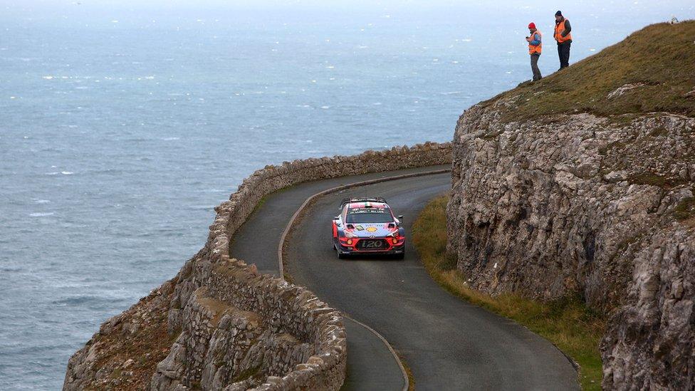 car driving along coast road