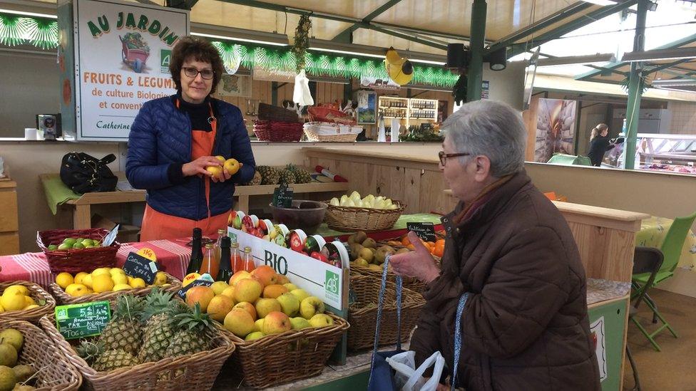 Market trader Catherine at her fruit and veg stall in Dole