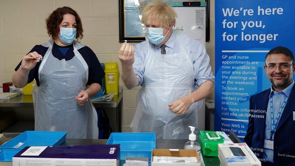 Prime Minister Boris Johnson is shown how to prepare the vaccine by advance nurse practitioner Sarah Sowden in Batley.