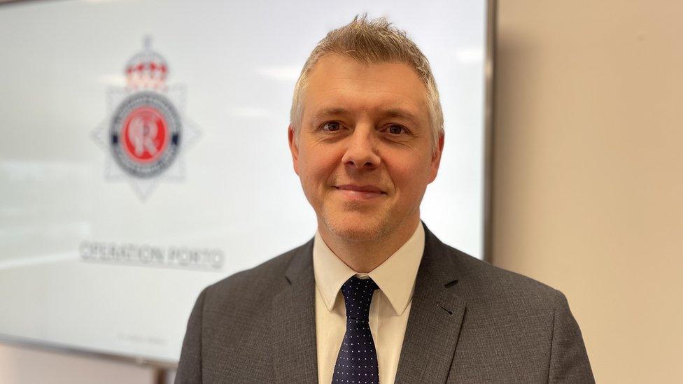 A man with salt and pepper hair in a suit