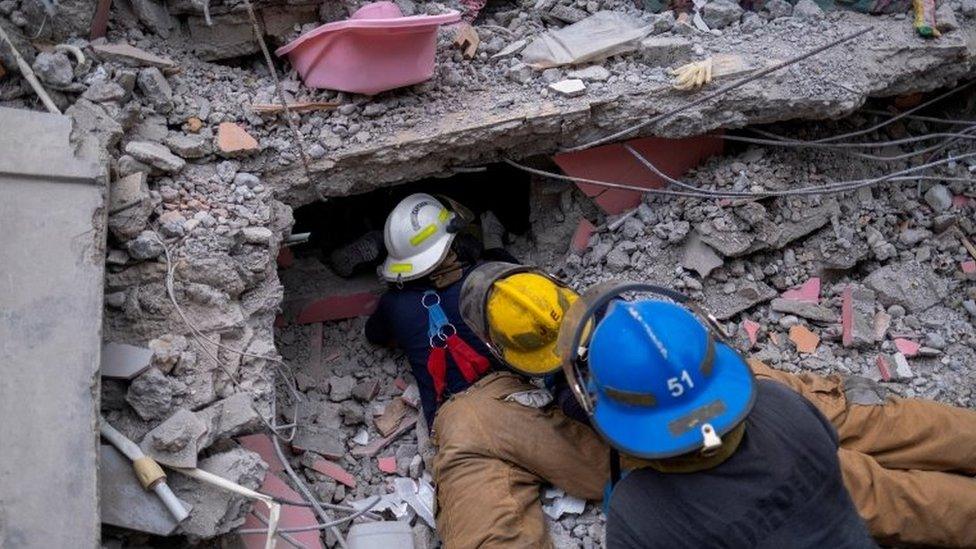 Haitian firefighters search for survivors, under the rubble of a destroyed hotel, after Saturday"s 7.2 magnitude quake, in Les Cayes, Haiti August 16, 2021