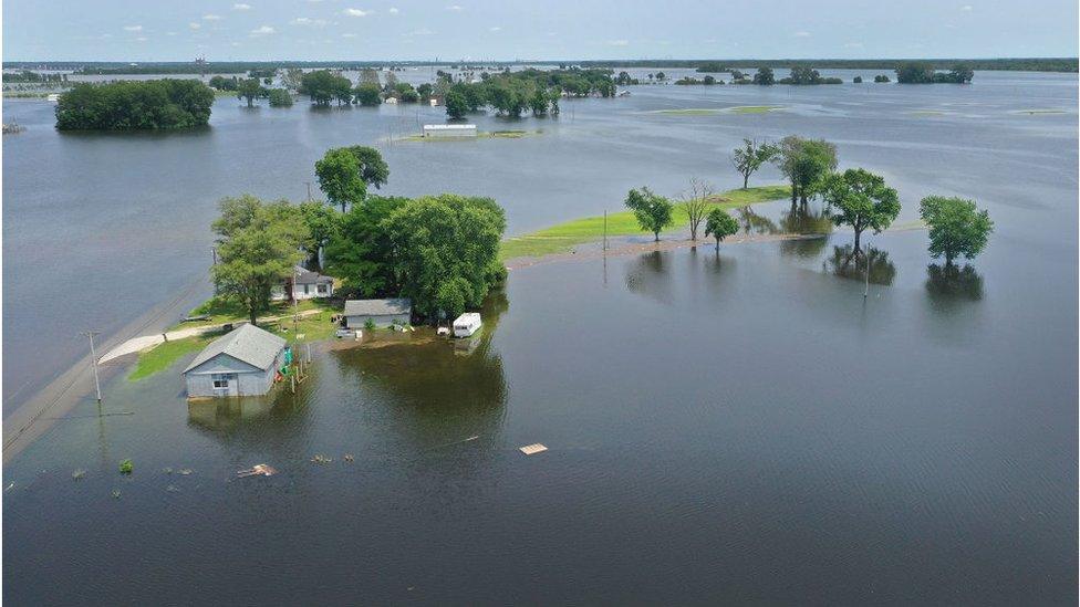 Mississippi floodwaters surround a Missouri home