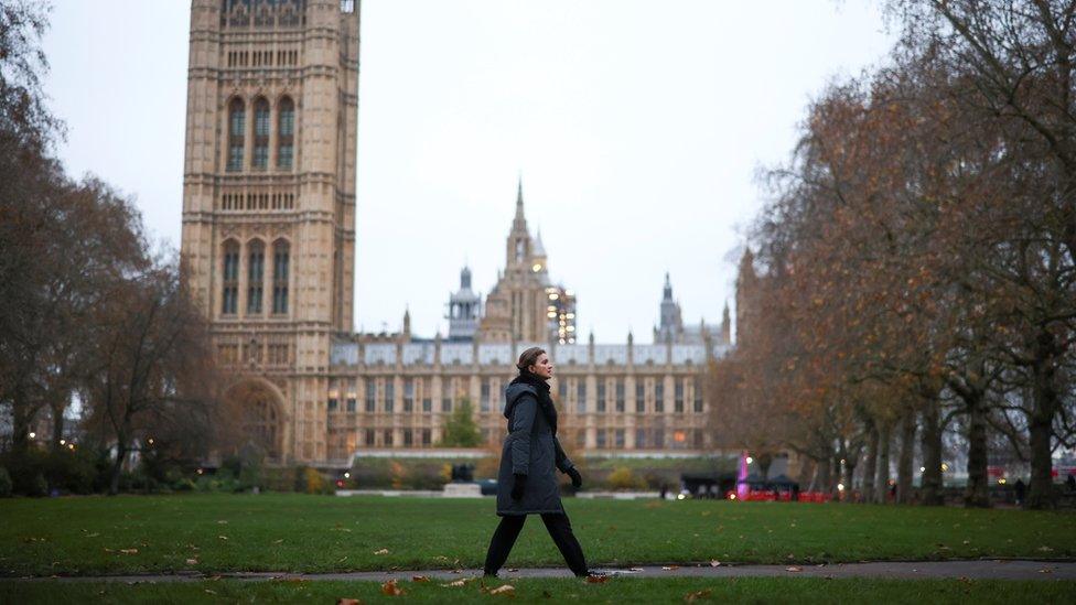 Woman walking in front of Parliament