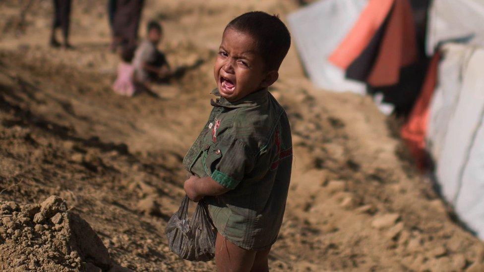 A Rohingya Muslim refugee child cries as he stands near the Thyangkhali refugee camp at Cox's Bazar, 29 November 2017