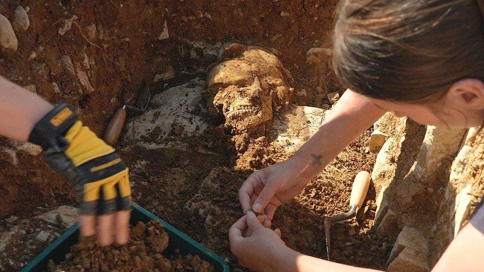 Skeleton in medieval graveyard