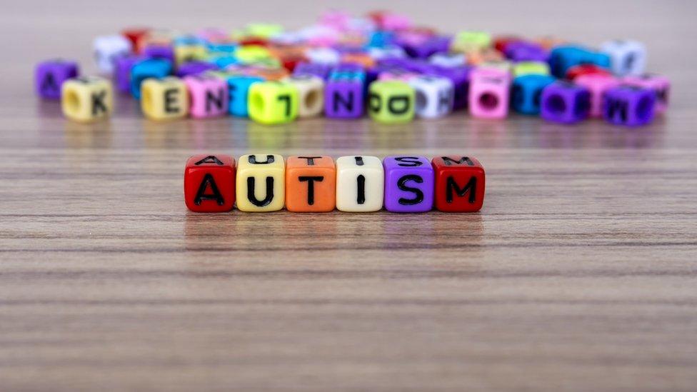 Autism word and alphabet letter beads - stock photo