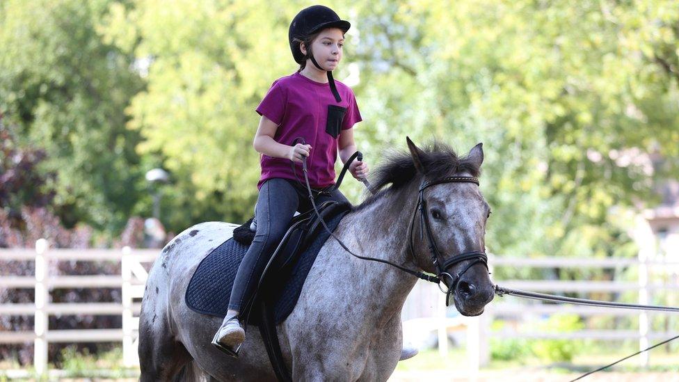 Girl riding horse