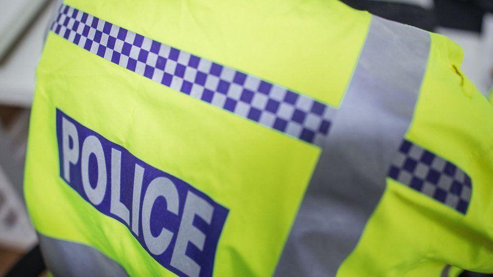 A stock photo of a police officer's jacket with the word POLICE emblazoned across the back.