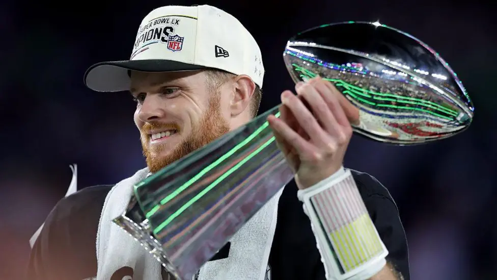 Sam Darnold holds the Lombardi Trophy