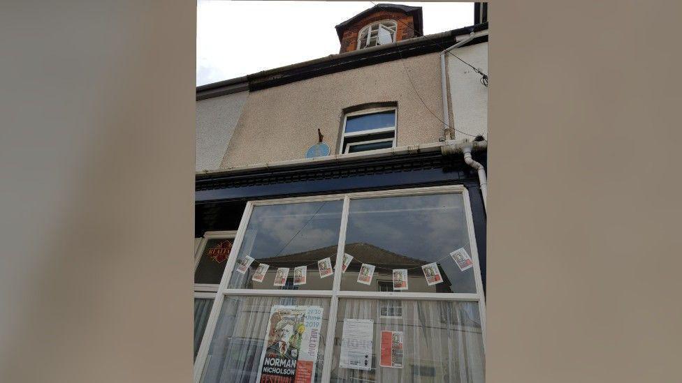 14 St George's Terrace. It is a three-storey beige house with large front windows and an attic room window.