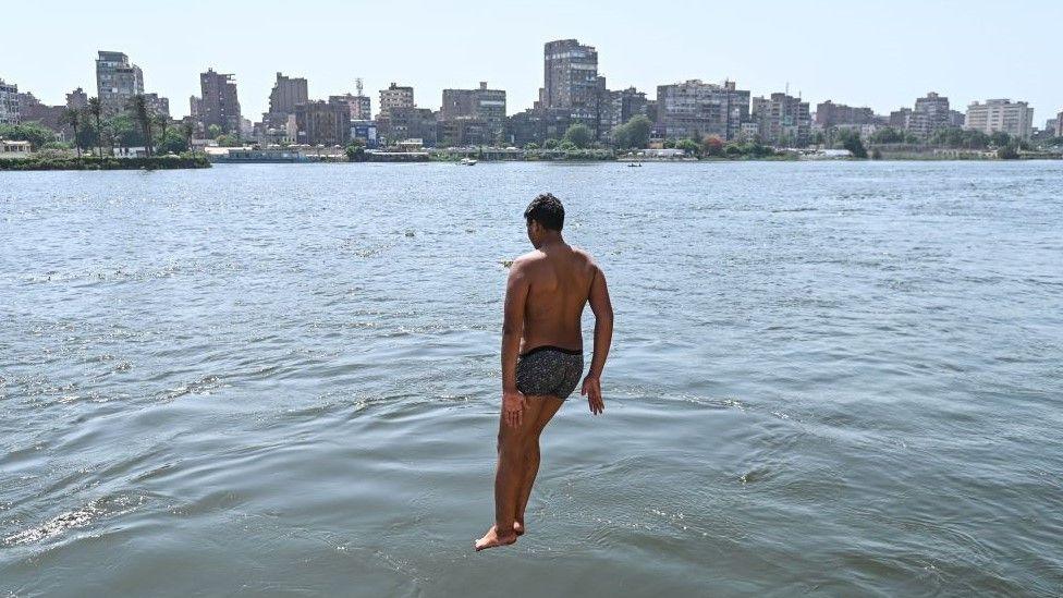 A boy jumps into the Nile River on 8 June.