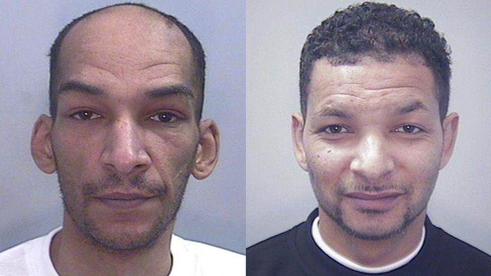 Mugshots of a bald man with a white t-shirt on the left and a man wearing a black top on the right