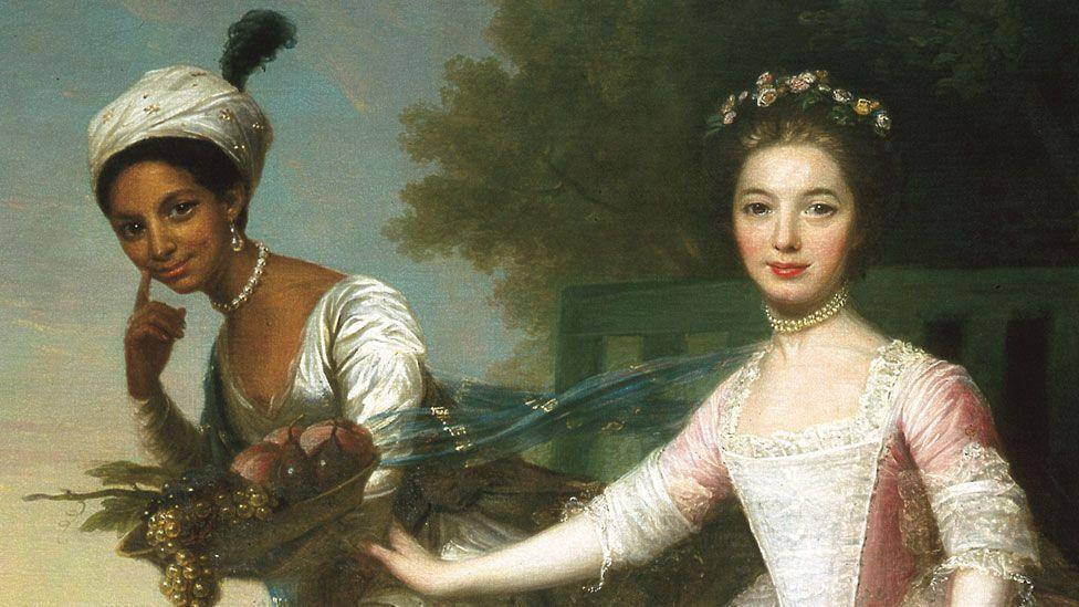 David Martin, Dido Elizabeth Belle and Lady Elizabeth Murray at Kenwood House, c.1776. This is a close-up of the portrait and shows Dido Belle on the left wearing a white dress, a choker of large pearls and a turban and in movement. Lady Elizabeth is seated, wearing pink and white, a double choker of pearls with flowers in her hair.