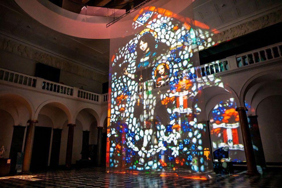 Image of woman and girl projected in an art gallery setting.