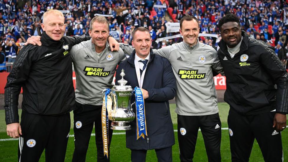 Leicester first team coach Adam Sadler, goalkeeping coach Mike Stowell, manager Brendan Rodgers, assistant manager Chris Davies and first team coach Kolo Toure celebrate winning the FA Cup in 2021
