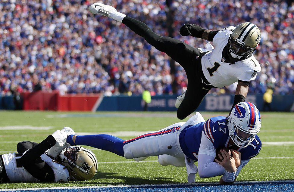 Josh Allen of the Buffalo Bills scores a touchdown against Alontae Taylor and Justin Reid of the New Orleans Saints during the third quarter in Orchard Park, New York. Photo by Bryan M. Bennett