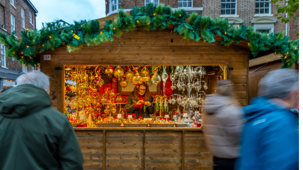 A wooden hit with a large display of Christmas themed items